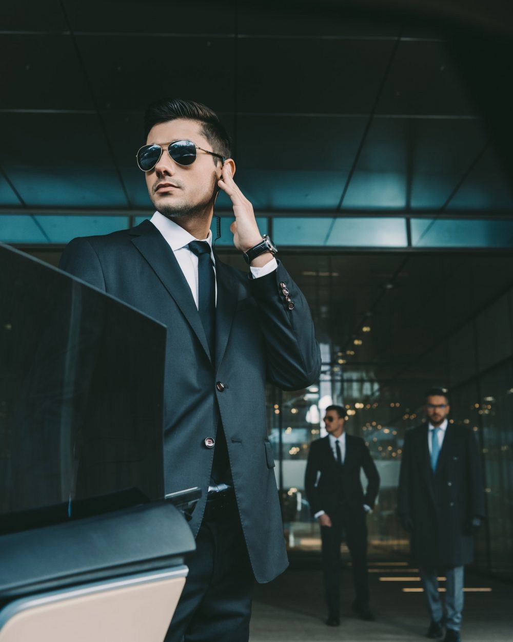bodyguard-opening-car-door-for-businessman-and-listening-security-earpiece.jpg bodyguard-opening-car-door-for-businessman-and-listening-security-earpiece.jpg